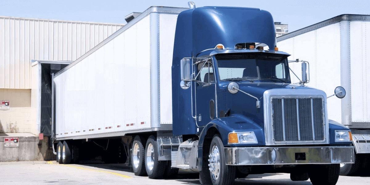 Shipping truck unloading at warehouse
