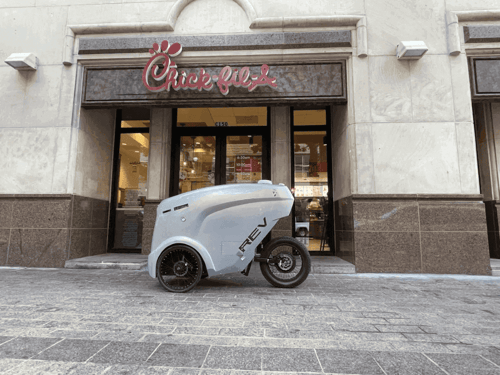 Small delivery robot outside Chick-Fil-A